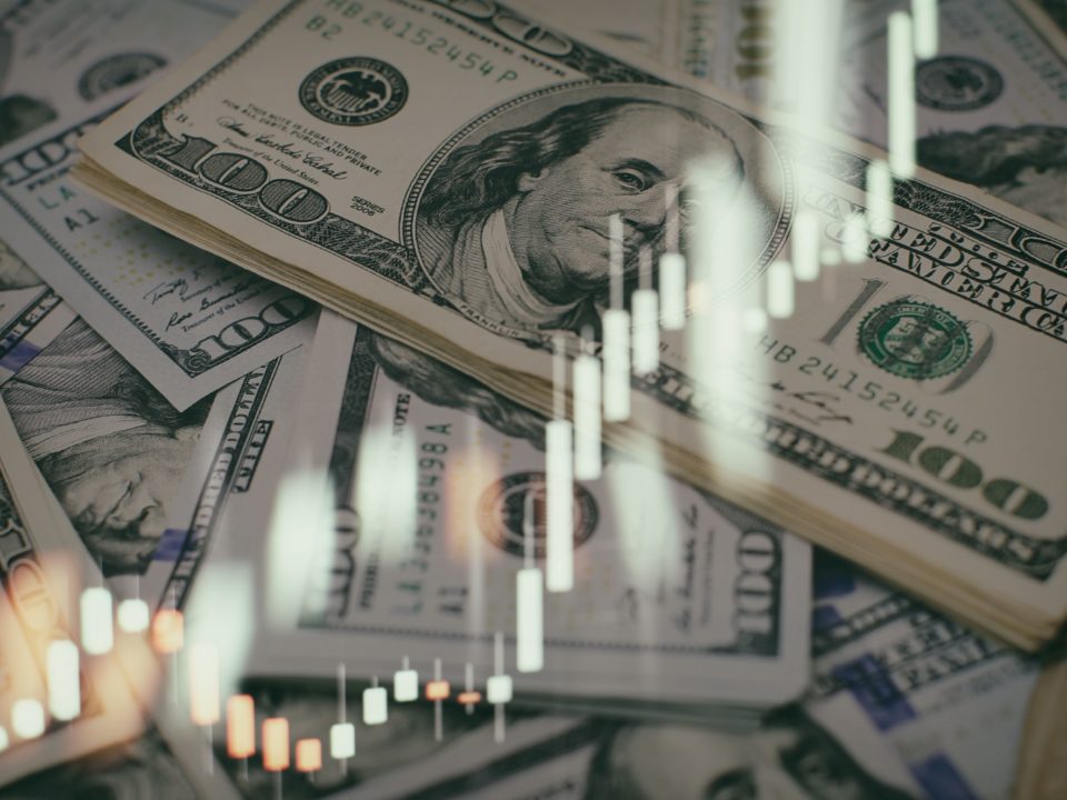USD banknotes and investment graph