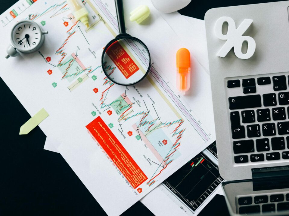 Stock market and hedge fund analytical process on desktop and paper